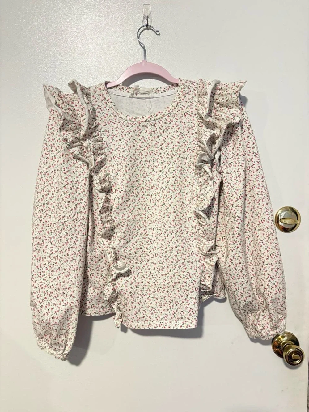 Anthropologie white cotton blouse with small pink ditzy floral print and ruffles